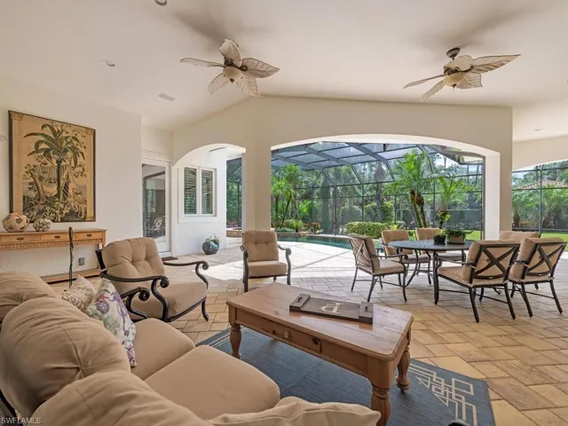 Expansive covered patio with a vaulted ceiling, dual ceiling fans
