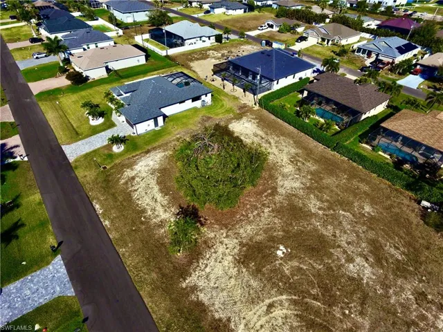 Aerial view of property and surrounding area with nearby suburban area