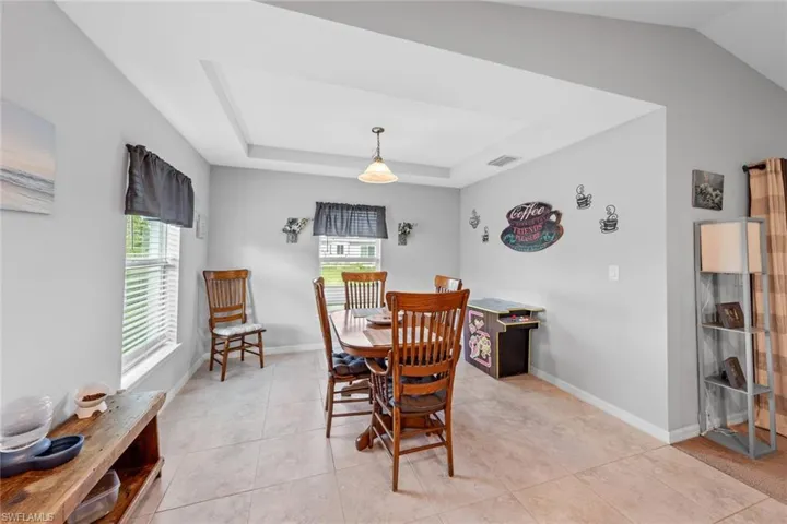 Tiled dining area featuring a wealth of natural light