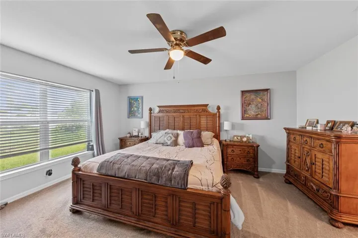 Bedroom featuring ceiling fan and light carpet