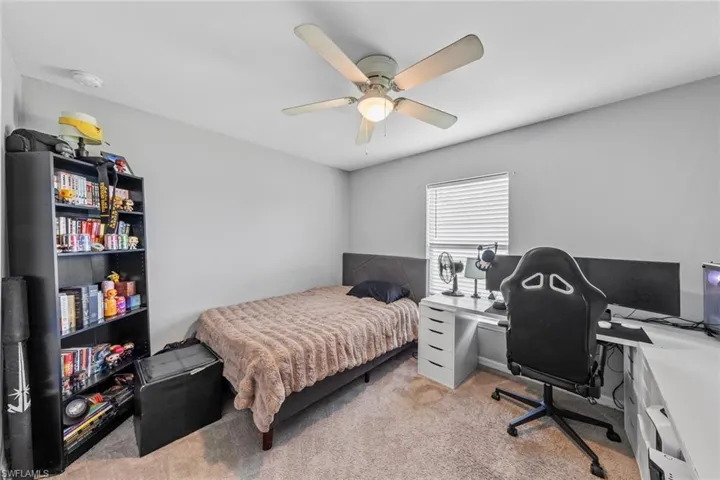 Bedroom with light colored carpet and ceiling fan