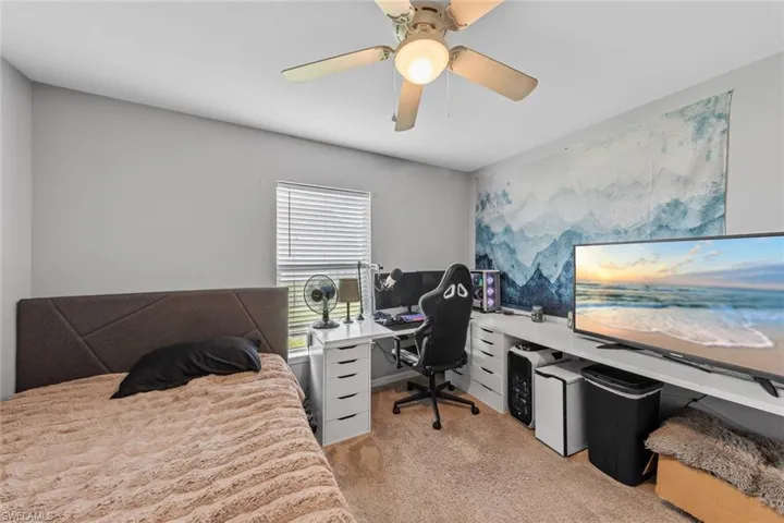 Carpeted bedroom with ceiling fan