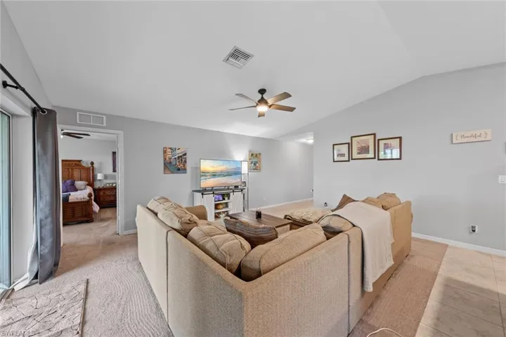 Living room featuring lofted ceiling and ceiling fan