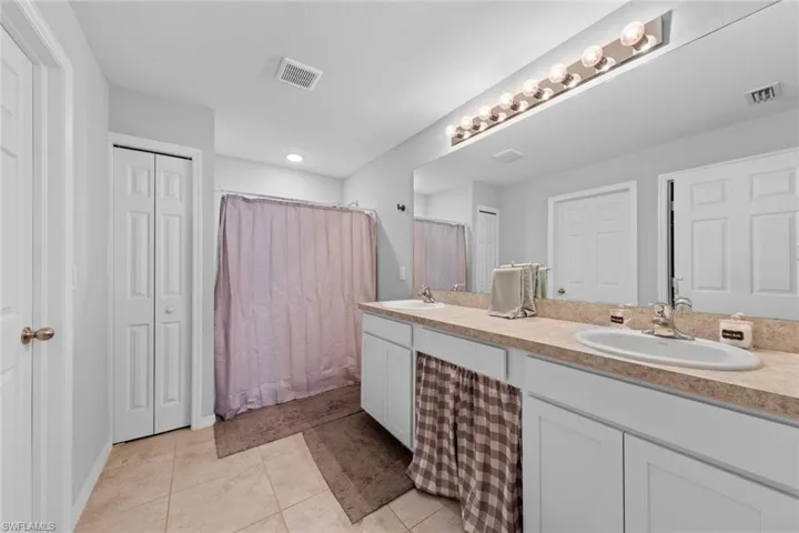 Bathroom with vanity and tile patterned floors