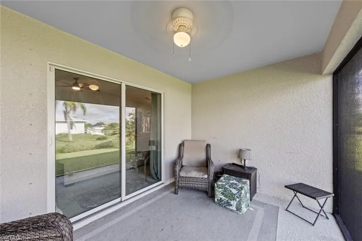 Office with ceiling fan and light carpet