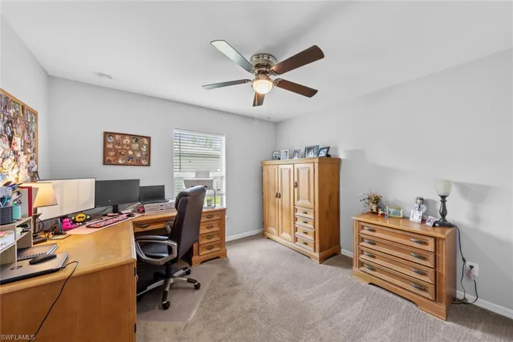 Carpeted office with ceiling fan