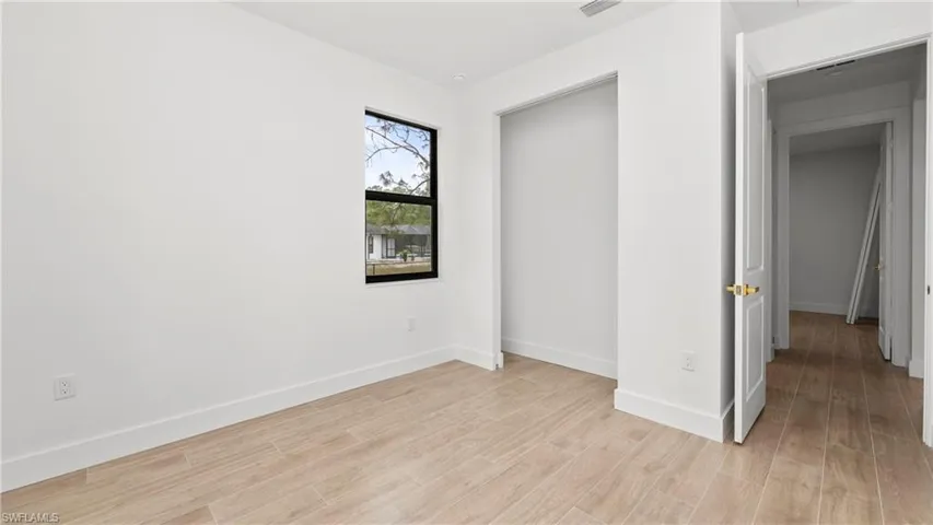 Unfurnished bedroom featuring baseboards and light wood-type flooring