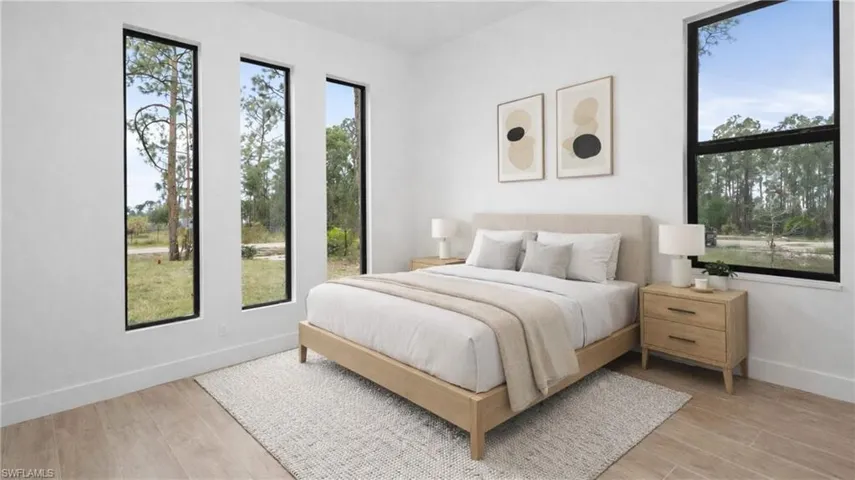 Virtually Staged Bedroom featuring light wood-style floors and multiple windows