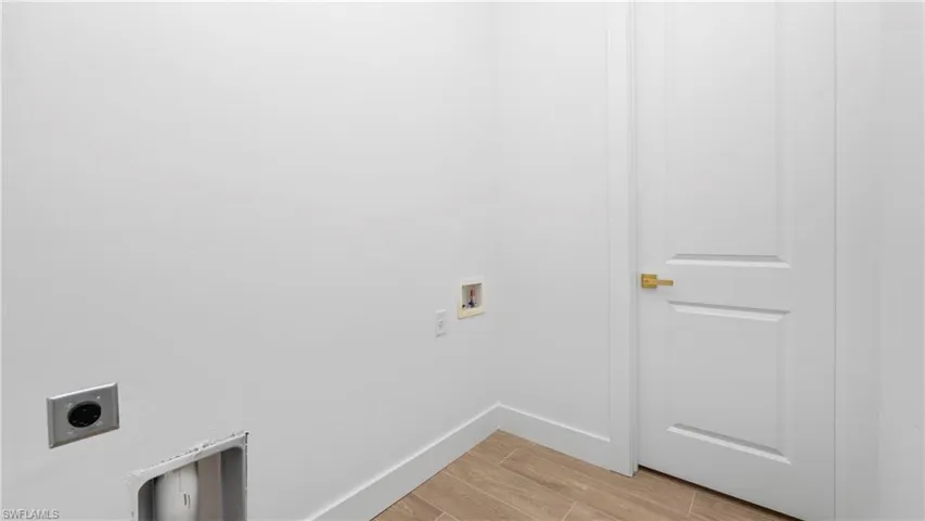 Laundry area featuring hookup for a washing machine, electric dryer hookup, and wood tiled floors
