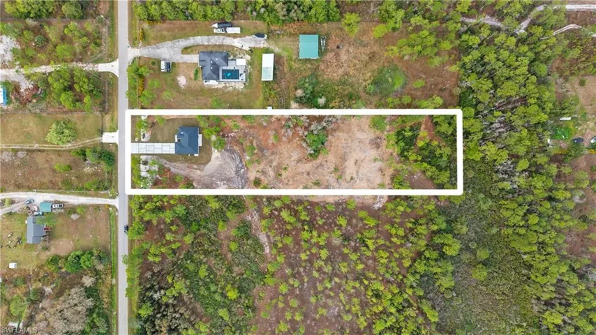 Aerial view of property and surrounding area featuring property boundaries highlighted