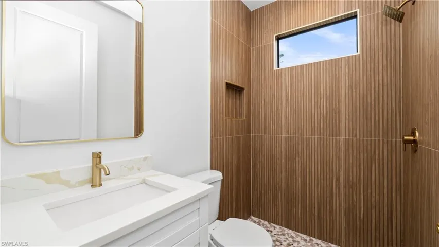 Full bath with vanity and a shower