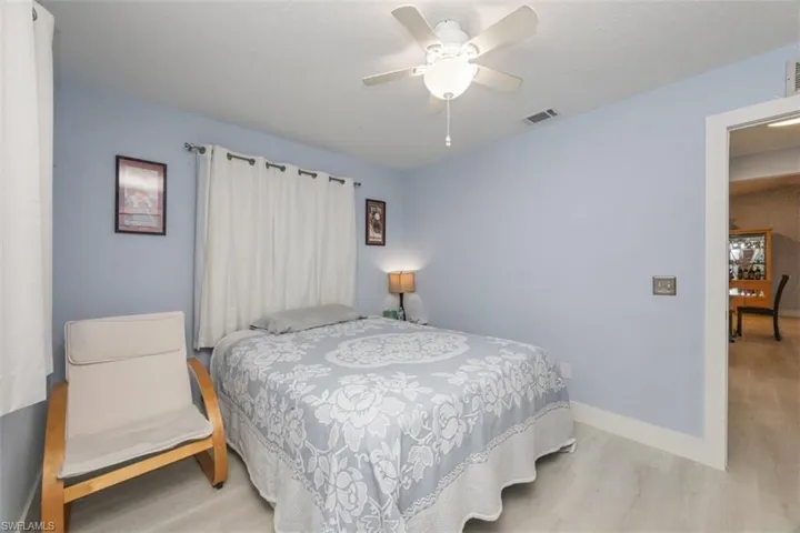 Bedroom with ceiling fan and wood finished floors