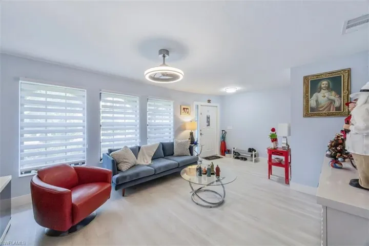 Living room with light wood finished floors and baseboards