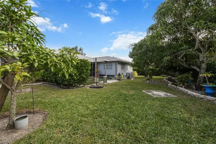 View of grassy yard with a patio area