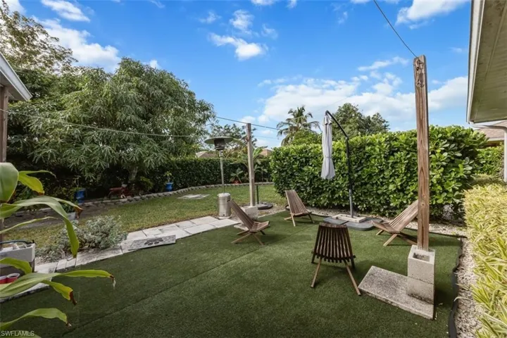 View of grassy yard with a patio