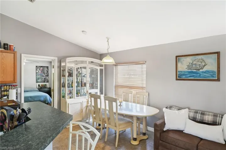 Dining space featuring baseboards and vaulted ceiling