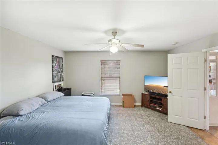 Bedroom featuring baseboards and ceiling fan