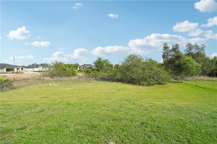 View of yard featuring fence