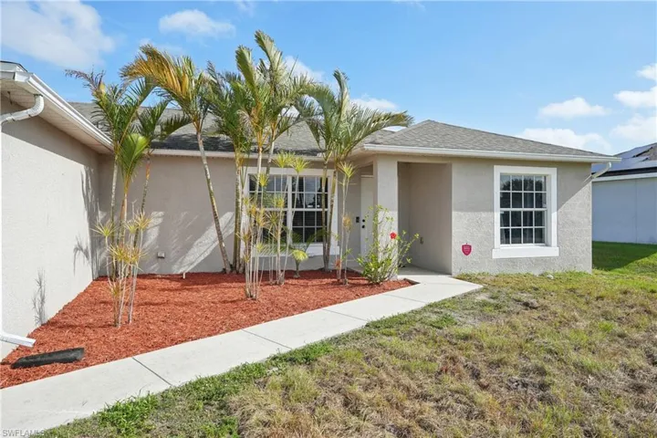 Single story home featuring stucco siding, a front lawn, and roof with shingles