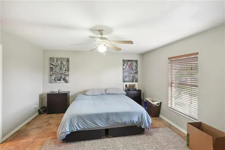 Bedroom with baseboards and a ceiling fan