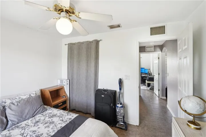 Bedroom featuring visible vents, ceiling fan, and tile patterned flooring
