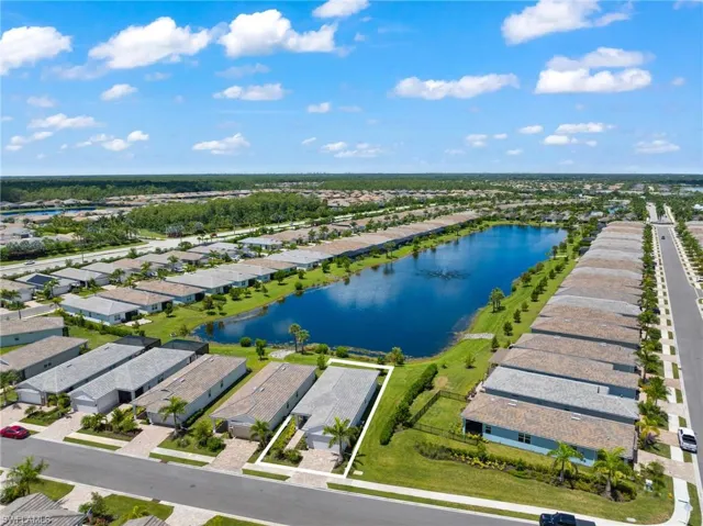 Birds eye view of property with a water view