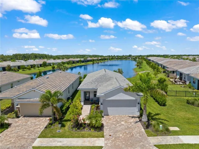 Birds eye view of property with a water view