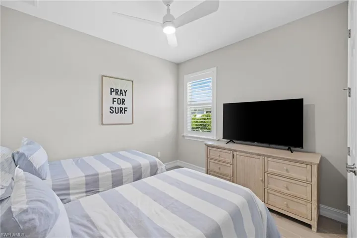 Bedroom with ceiling fan and light hardwood / wood-style floors
