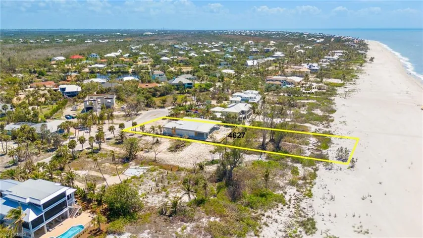Drone / aerial view with a beach view and a water view