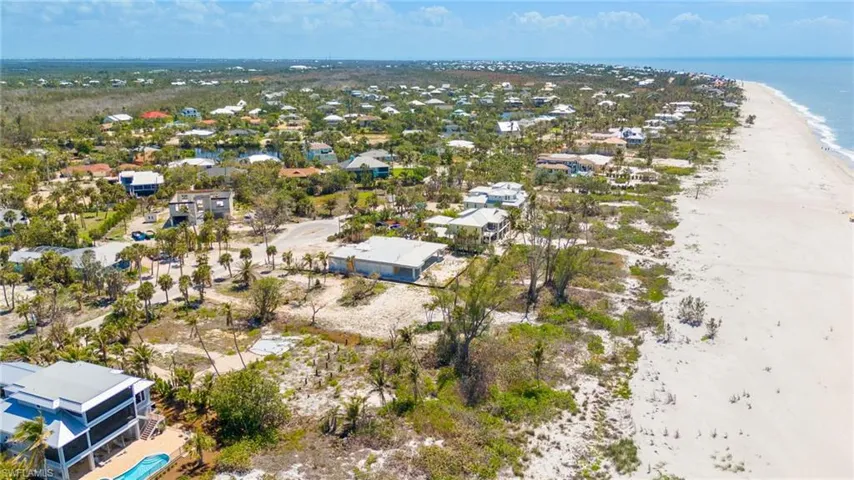 Drone / aerial view featuring a residential view, a view of the beach, and a water view