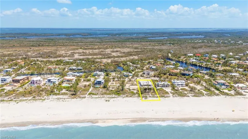 Drone / aerial view with a residential view, a view of the beach, and a water view