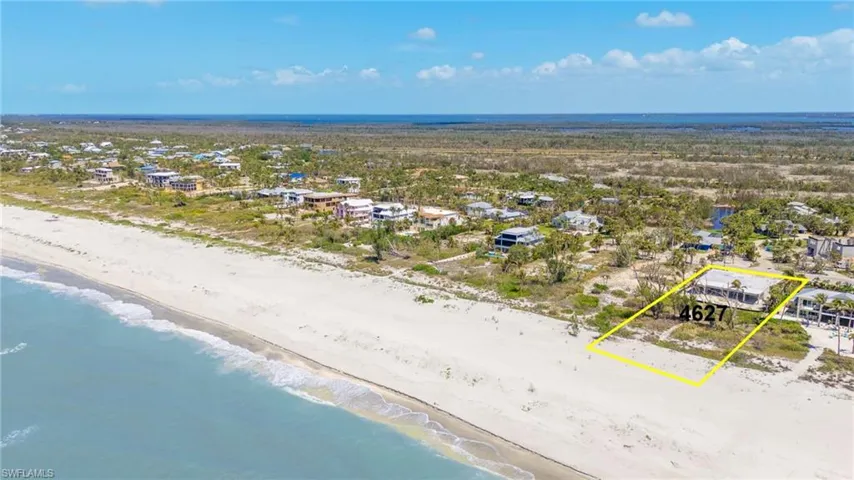 Birds eye view of property with a view of the beach and a water view