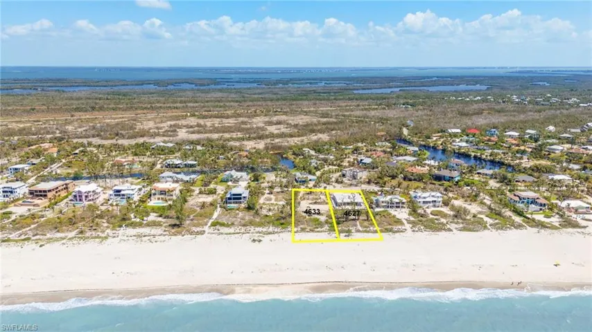 Drone / aerial view with a beach view, a residential view, and a water view