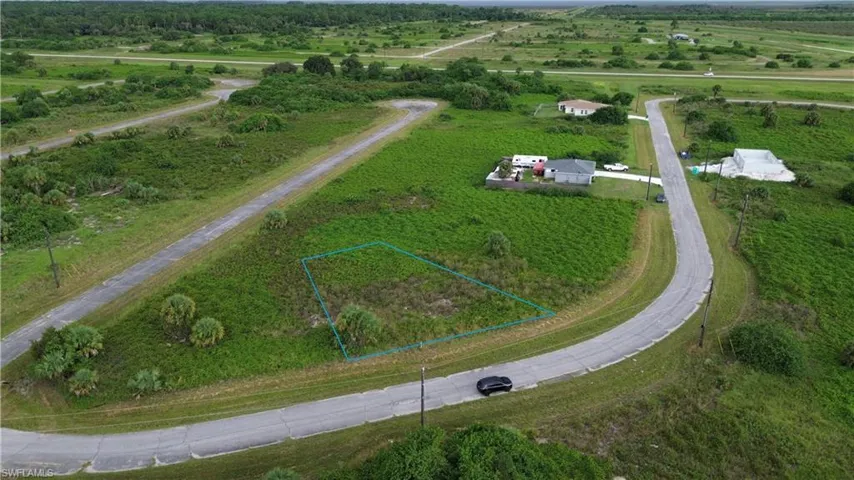 Aerial view of sparsely populated area featuring property boundaries highlighted