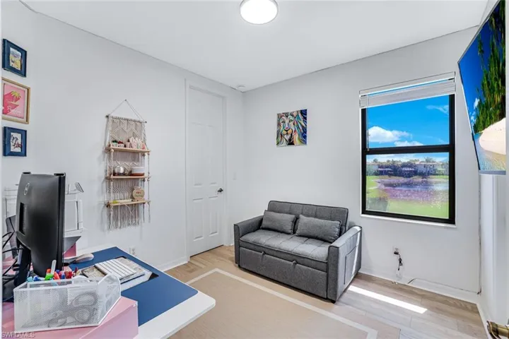 Office with light wood-style flooring and baseboards