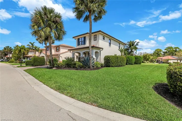 Mediterranean / spanish house with stucco siding and a front lawn