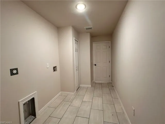 Laundry room with electric dryer hookup and baseboards