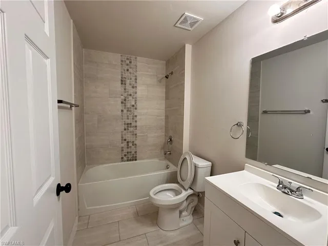Full bath with vanity and bathtub / shower combination