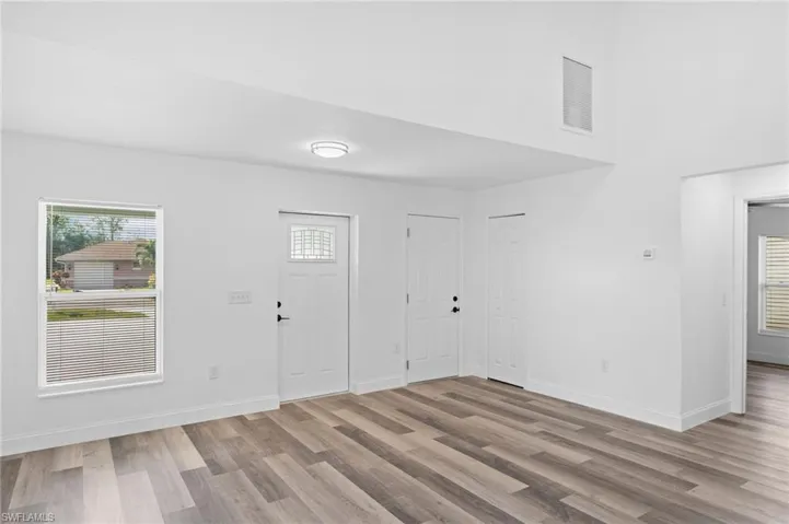 Entryway with healthy amount of natural light and light wood-style floors