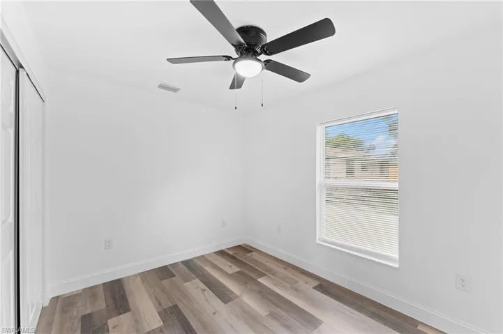 Empty room with light wood-style flooring and ceiling fan