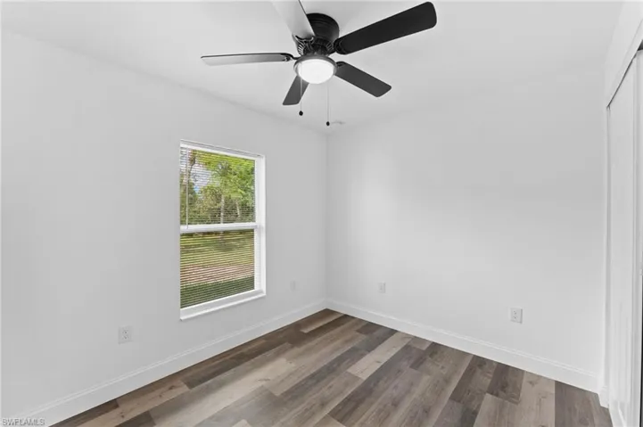Unfurnished room featuring wood finished floors and a ceiling fan