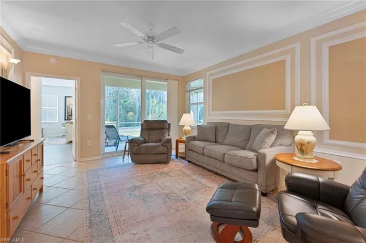 Sizable Living Room Flanked by Windows and View to Landscaping and Preserve