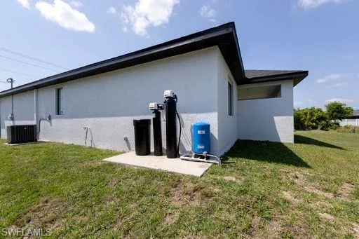 Side of home with AC and water system