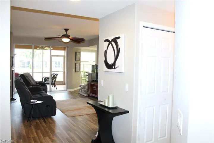 Living room with hardwood / wood-style flooring and ceiling fan