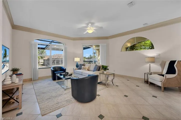PREVIOUSLY STAGED VIEW: Family room with spiral staircase down to pool and lanai