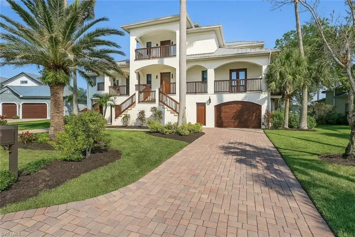 Virtually Painted:View of front of home with stucco siding, decorative driveway, a garage, a front yard, and stairway