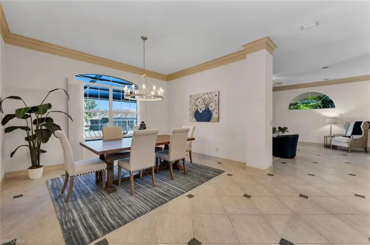 PREVIOUSLY STAGED VIEW:: Formal dining area with crown molding.