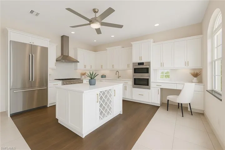 Virtually Staged:Kitchen with stainless steel appliances, wall chimney range hood, dark tile patterned flooring, white cabinets, and recessed lighting