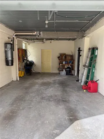 View of garage with door to work room