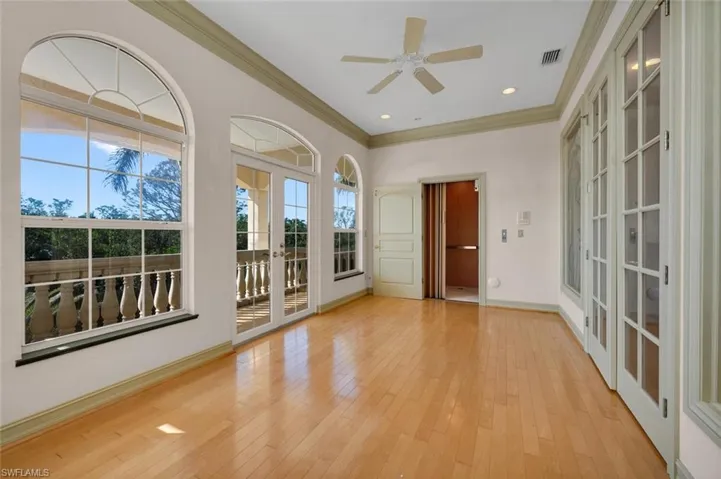 Den with french doors and a patio and elevator access on 3rd floor